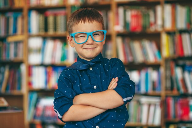 Winking boy with glasses in library