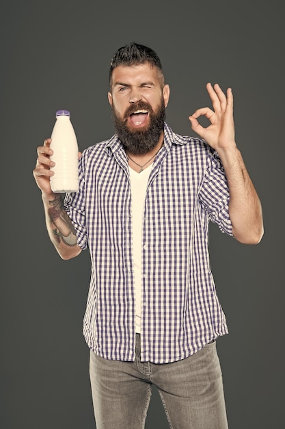 winking man hold milk bottle for breakfast dairy product