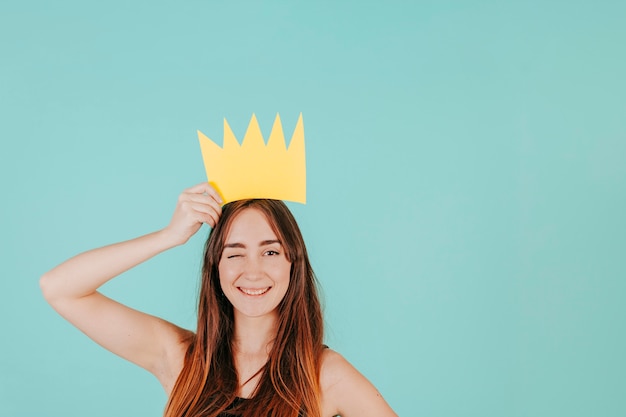 Winking woman with paper crown
