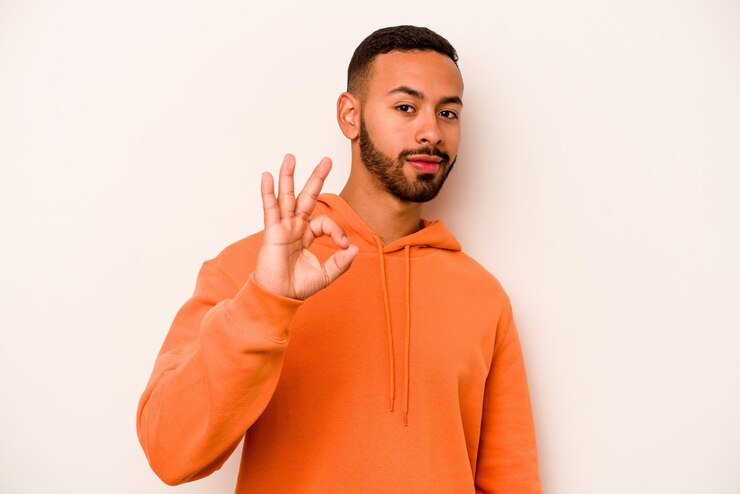 Photo winks an eye and holds an okay gesture with hand