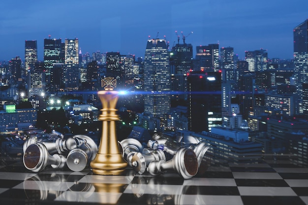 Winner. golden king surrounded with silver chess pieces on chess board game competition with graphic modern night light city background, business strategy, chess battle, success, team leader concept