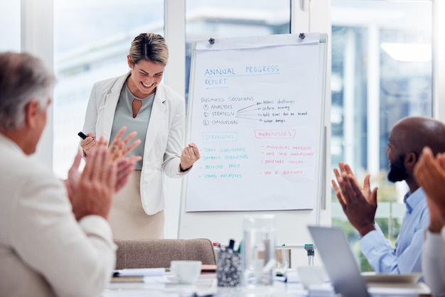 Winner success and applause with a business woman cheering during a presentation to her team in the boardroom Meeting motivation or wow with a female employee and colleague group in an office