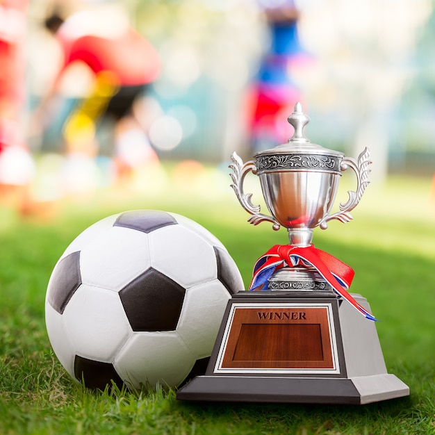 Winner trophy and soccer ball at the competition sport court