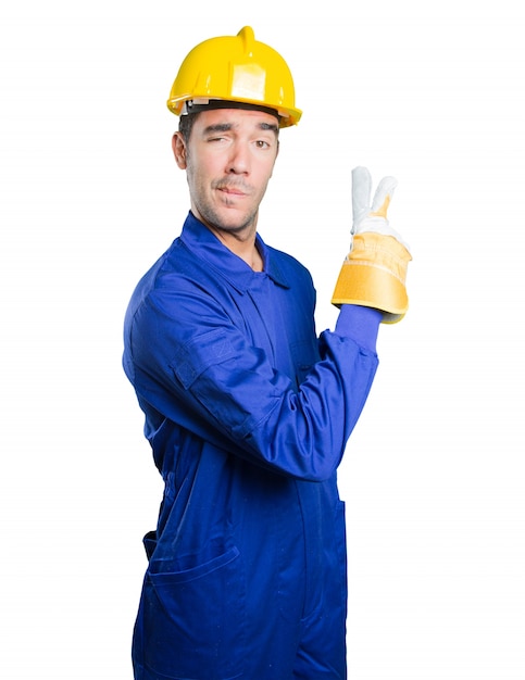 Winner workman with victory gesture on white background