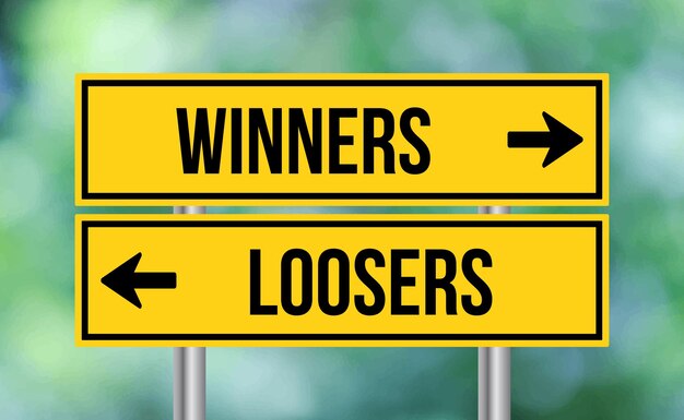 Winners or loosers road sign on blur background