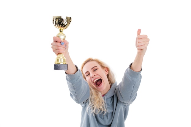 Photo winning competitions a young woman with a golden cup selective focus on the cup isolated