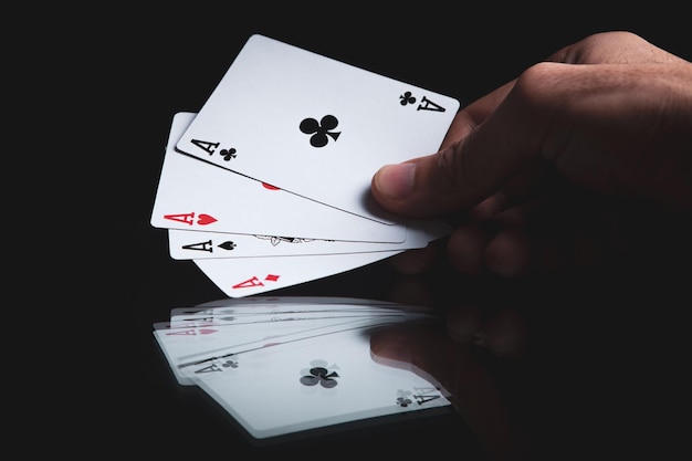 Winning poker hand of four aces playing cards