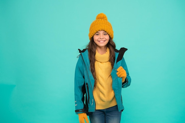 Winter activities. Winter holidays. knitted clothes fashion. cold season weather. activity for kids. small girl sweater. hat and gloves accessory. no flu. warm clothes sales. happy girl anorak jacket.