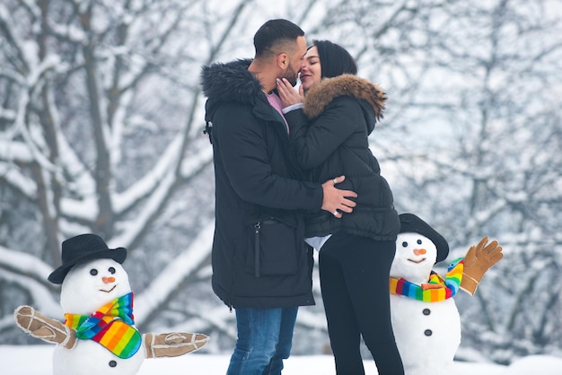 Winter adventure. Passionate man gently kissing beautiful woman with desire. Kissing winter couple portrait.