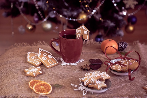 Winter aesthetic lifestyle Hot chocolate ginger cookies tangerines near Christmas tree Cozy warm home