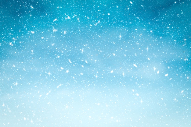 Winter background with snow and glitter in blue gradient color. 