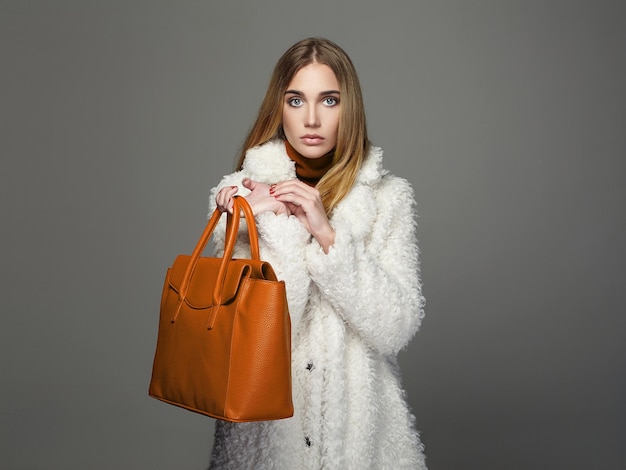 Winter beautiful Woman with orange Handbag