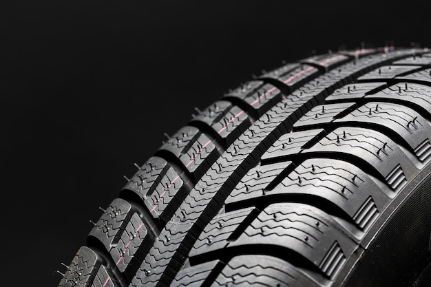 Photo winter car tires closeup wheel profile structure on black background