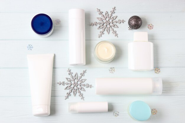 Winter care cosmetics on a colored background top view