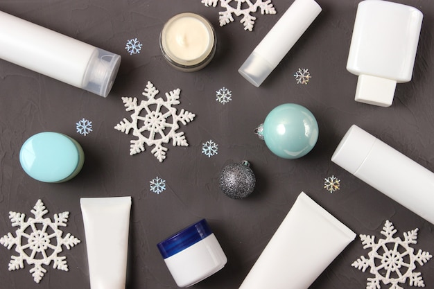 Winter care cosmetics on a colored background top view