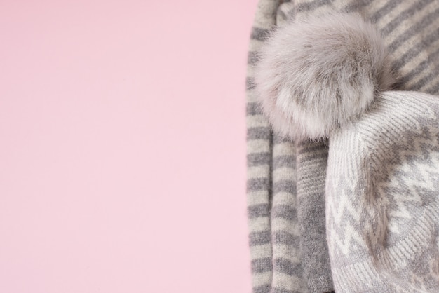 Winter cloth hat on pink, copyspace