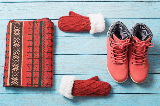 Winter clothes and shoes on wood