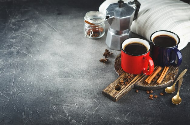 Winter coffee with spices in color enamelled cups