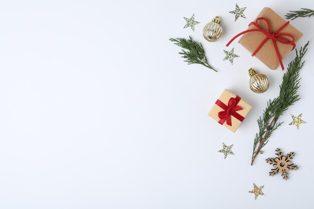 Winter composition with fir tree and gift boxes on white background top view