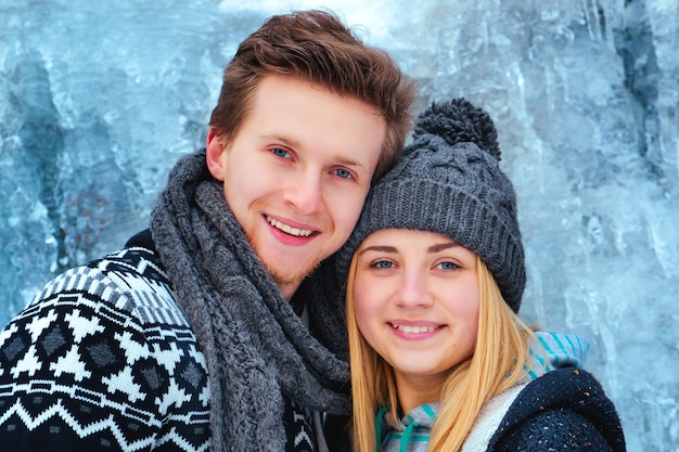 Winter couple piggyback in snow smiling happy and excited. Beautiful young multiracial couple,