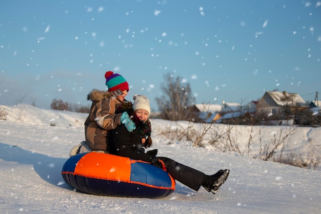 On a winter day children go sledding and laugh merrily