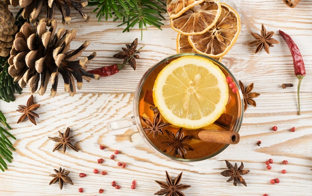 Winter drink with spices on wooden table