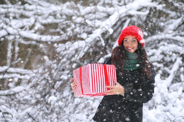 A winter fairy tale a young mother and her daughter ride a sled in the forest