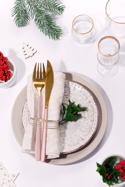 Winter festive table setting with cutlery on table. Top view. Christmas tableware.
