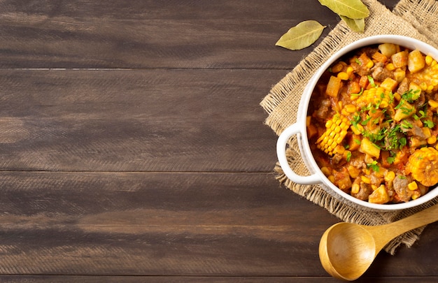 winter food stew in bowl on burlap fabric copy space