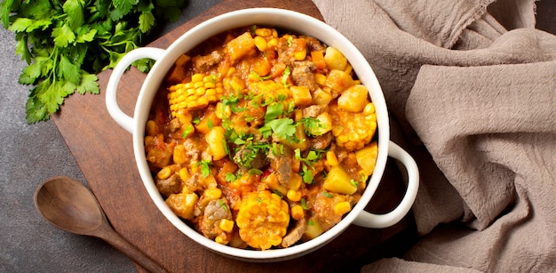 Photo winter food stew in bowl and cloth flat lay