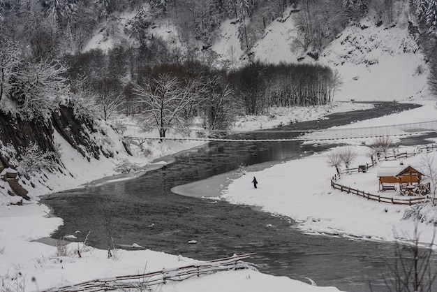 Winter forest and river in mountain region Winter vacations