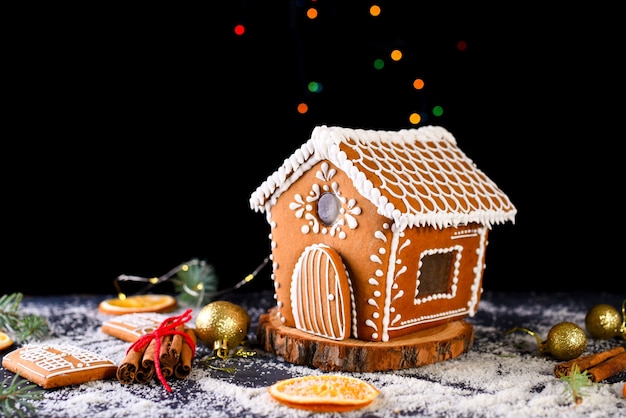 Winter gingerbread house with light from the windows