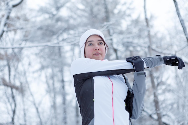 Winter girl on stretching exercises