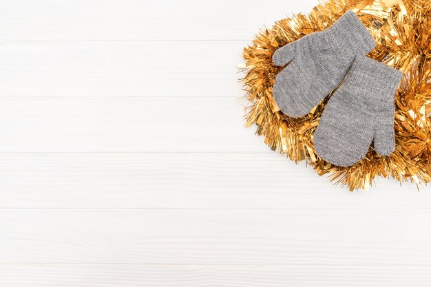 Winter gloves on white wooden surface