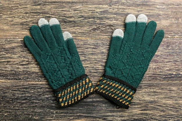 Winter gloves on wooden background