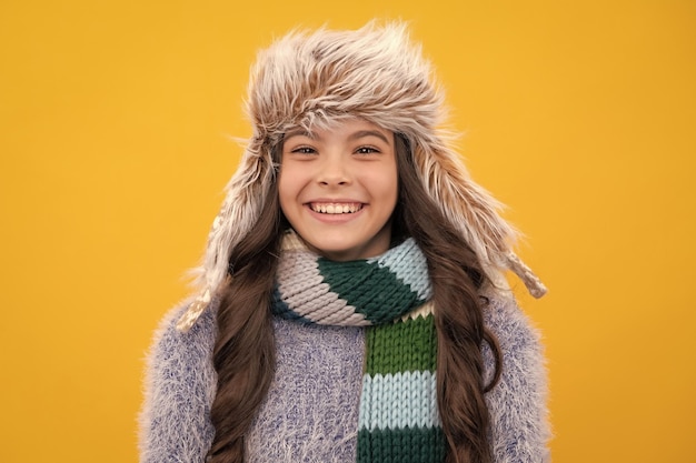 Winter hat cold season concept winter fashion accessory for\
children teen girl wearing warm knitted hat happy face positive and\
smiling emotions of teenager girl