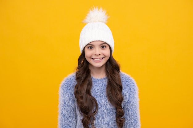 Winter hat Cold season concept Winter fashion accessory for children Teen girl wearing warm knitted hat Happy girl face positive and smiling emotions