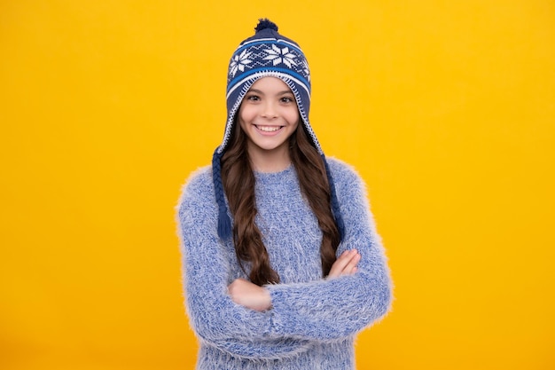 Winter hat cold season concept winter fashion accessory for children teen girl wearing warm knitted hat happy girl face positive and smiling emotions