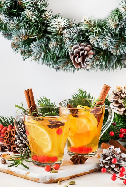 Winter hete thee met citroen veenbessen kruiden en specerijen voor Kerstmis of Nieuwjaar avond witte achtergrond kopie ruimte selectieve focus