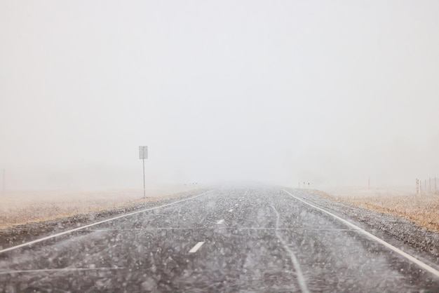 winter highway snowfall background fog poor visibility