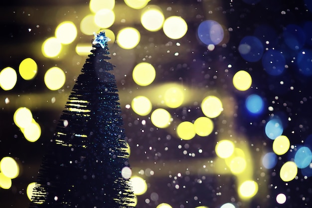 Winter holiday background with frozen fir, glitter lights, bokeh. Christmas and New Year holiday background with copy space.