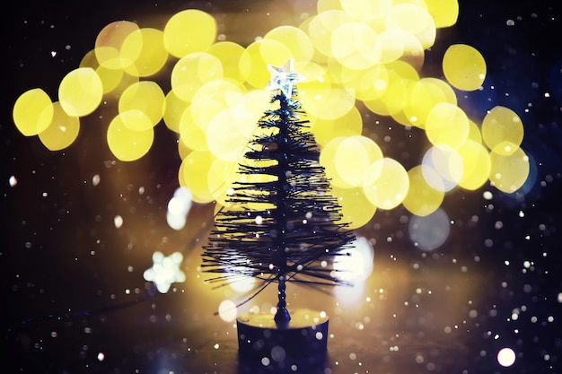 Winter holiday background with frozen fir, glitter lights, bokeh. Christmas and New Year holiday background with copy space.