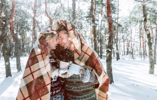 Winter holiday concept. couple in love is having fun under the snow.