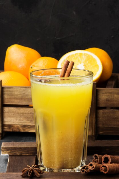 Winter hot drink from oranges and spices on black