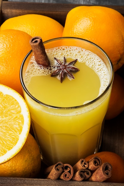 Winter hot drink from oranges and spices on black