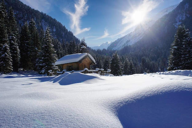 Winter house in mountain snow panoramic landscape at Christmas