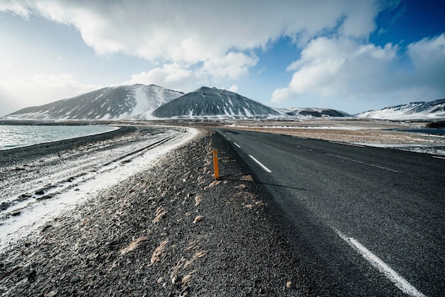 Winter iceland landscape traveling along the golden ring in
iceland by car winter when the ground and the mountains are covered
by snow winter road