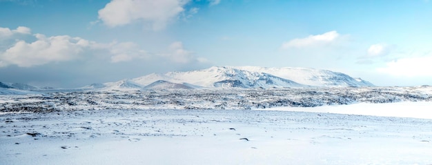 Winter iceland landscape traveling along the golden ring in\
iceland by car winter when the ground and the mountains are covered\
by snow winter road