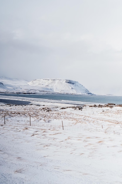 Winter iceland landscape traveling along the golden ring in\
iceland by car winter when the ground and the mountains are covered\
by snow