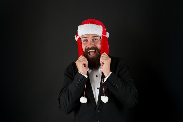 Winter is calling Happy businessman dark background Bearded man with winter party look Winter fashion and accessory Festive winter season New year celebration Merry christmas greetings